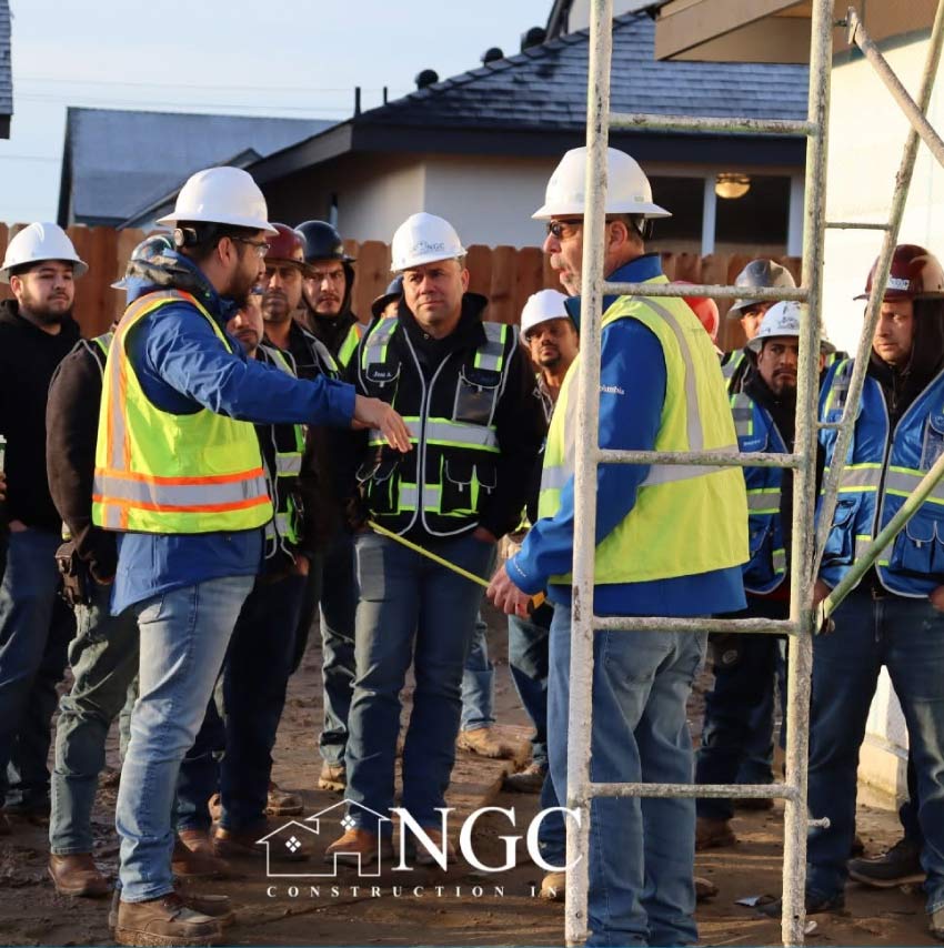 NGC Construction crew reviewing measurements and job details on a residential construction site