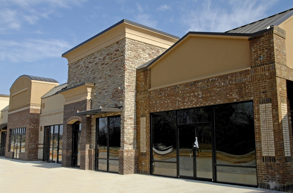 Completed retail storefront building with stone and brick exterior finish